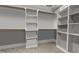 Walk-in closet with installed shelving, gray walls, carpet floors, and natural lighting from a window at 3587 Garner Terrace Way, Wake Forest, NC 27587