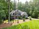 Charming home exterior featuring a well-kept lawn, stone accents, and lush landscaping enhancing its curb appeal at 3587 Garner Terrace Way, Wake Forest, NC 27587