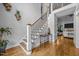 Welcoming foyer with hardwood floors, staircase with iron railings, and elegant decor at 3587 Garner Terrace Way, Wake Forest, NC 27587