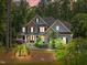 Charming two-story home with stone accents, beautiful landscaping, and a lush, wooded backdrop at 3587 Garner Terrace Way, Wake Forest, NC 27587