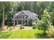 Attractive two-story home featuring stone accents, manicured lawn, and mature trees at 3587 Garner Terrace Way, Wake Forest, NC 27587
