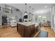Stylish kitchen island with granite countertops, stainless steel sink, and views into the living room at 3587 Garner Terrace Way, Wake Forest, NC 27587