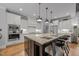 Gourmet kitchen boasts granite counters, stainless appliances, and a large island with seating at 3587 Garner Terrace Way, Wake Forest, NC 27587