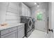 Well-lit laundry room with modern appliances, ample storage, and a convenient utility sink at 3587 Garner Terrace Way, Wake Forest, NC 27587