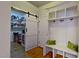 Mudroom featuring custom storage lockers, bench and pantry with barn door at 3587 Garner Terrace Way, Wake Forest, NC 27587
