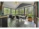Inviting screened porch with ceiling fan and wooded views, ideal for outdoor dining and relaxation at 3587 Garner Terrace Way, Wake Forest, NC 27587