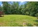 Backyard featuring a large manicured lawn and wooded area at 39 Blue Heron Ct, Kenly, NC 27542