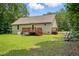 Back exterior of the home with a deck, patio, and play set at 39 Blue Heron Ct, Kenly, NC 27542