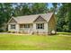 Charming single-story home featuring a front porch, manicured lawn, and a propane tank discreetly placed at 39 Blue Heron Ct, Kenly, NC 27542