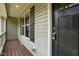 Close-up of the front porch showcases a welcoming entry with dark shutters, siding, and painted wood porch at 39 Blue Heron Ct, Kenly, NC 27542