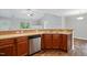 Shows the kitchen with stainless steel dishwasher, double sink, countertops and hardwood floors at 39 Blue Heron Ct, Kenly, NC 27542