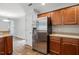 Kitchen featuring stainless steel refrigerator, wood cabinets, countertops, and hardwood floors at 39 Blue Heron Ct, Kenly, NC 27542