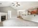 Open-concept living room with vaulted ceilings, a fireplace, and seamless flow into the kitchen at 39 Blue Heron Ct, Kenly, NC 27542