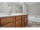 Main bathroom with double sink vanity, framed mirror, walk-in shower, and separate soaking tub at 39 Blue Heron Ct, Kenly, NC 27542