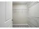 Walk-in closet with built-in white wire shelving and carpeted floor at 39 Blue Heron Ct, Kenly, NC 27542