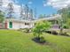 Manicured backyard with a green door, mature landscaping and a screened-in porch at 3934 Hope Valley Rd, Durham, NC 27707