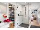 Bathroom featuring a modern glass enclosed shower, walk-in closet, and sink with wood vanity at 3934 Hope Valley Rd, Durham, NC 27707