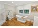 Modern bathroom with separate shower, soaking tub, and natural light at 3934 Hope Valley Rd, Durham, NC 27707