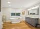 Bright bathroom featuring a soaking tub, double vanity and large window at 3934 Hope Valley Rd, Durham, NC 27707