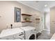 Laundry room with modern appliances, minimalist shelving, and plenty of room for storage at 3934 Hope Valley Rd, Durham, NC 27707