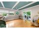 Bright living room with hardwood floors, large windows, and access to the outdoor patio at 3934 Hope Valley Rd, Durham, NC 27707