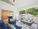 Inviting screened patio featuring stylish furniture and scenic views of the surrounding landscape at 3934 Hope Valley Rd, Durham, NC 27707