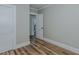 This bedroom features wood flooring and access to additional rooms at 408 N Maple St, Graham, NC 27253