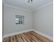 This bedroom features wood flooring, a window, and neutral paint color at 408 N Maple St, Graham, NC 27253