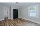 Bedroom with wood flooring, closet, and access to an attached bathroom at 408 N Maple St, Graham, NC 27253