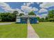 Beautiful home with blue brick exterior, complemented by lush green lawn and bright blue skies at 408 N Maple St, Graham, NC 27253