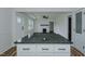Renovated kitchen with granite island and an open view to the living room at 408 N Maple St, Graham, NC 27253