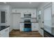 Updated kitchen featuring new cabinets, stainless appliances, and modern lighting at 408 N Maple St, Graham, NC 27253