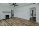 Spacious living room features refinished wood floors and a white brick fireplace at 408 N Maple St, Graham, NC 27253