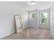 This bedroom offers ample light and a mirror for a stylish and bright space at 412 Heritage Village Ln, Apex, NC 27502