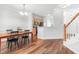 Open dining area with wood floors, stylish light fixture, and kitchen access at 412 Heritage Village Ln, Apex, NC 27502