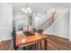 Cozy dining room with a wood table, open to kitchen, and a view of the stairs at 412 Heritage Village Ln, Apex, NC 27502