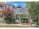 Charming townhouse with a cozy front porch, beautiful landscaping, and colorful trees at 412 Heritage Village Ln, Apex, NC 27502