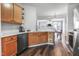 Stylish kitchen featuring stainless steel appliances, wood cabinets, and granite countertops at 412 Heritage Village Ln, Apex, NC 27502
