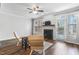 Cozy living room with a fireplace, hardwood floors, and plenty of natural light at 412 Heritage Village Ln, Apex, NC 27502