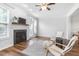 Bright living room featuring a fireplace, hardwood floors, and natural light at 412 Heritage Village Ln, Apex, NC 27502