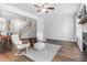 Open-concept living area with hardwood floors, a fireplace, and modern furniture at 412 Heritage Village Ln, Apex, NC 27502