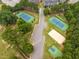Aerial view of tennis courts and recreational facilities nestled among lush trees at 412 Heritage Village Ln, Apex, NC 27502