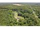 Expansive aerial view of a home enveloped by lush, mature trees and greenery at 4403 Jeffries Rd, Durham, NC 27704