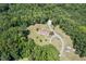 Aerial view of home on wooded acreage featuring a circular driveway at 4403 Jeffries Rd, Durham, NC 27704