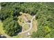 From above, a charming home is seen set back on a sizable lot, embraced by a dense canopy of trees at 4403 Jeffries Rd, Durham, NC 27704