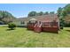 Inviting home with a wood deck, green lawn and steps leading down into the back yard at 4403 Jeffries Rd, Durham, NC 27704