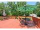 Relax on this home's spacious wood deck that includes outdoor seating and umbrella-shaded table at 4403 Jeffries Rd, Durham, NC 27704