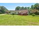 Spacious backyard featuring a deck, mature trees, and well-maintained lawn at 4403 Jeffries Rd, Durham, NC 27704