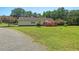 Expansive backyard with a deck and mature trees, ideal for outdoor gatherings at 4403 Jeffries Rd, Durham, NC 27704