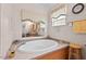 Bathroom featuring a soaking tub, window with curtain, and tiled floors at 4403 Jeffries Rd, Durham, NC 27704